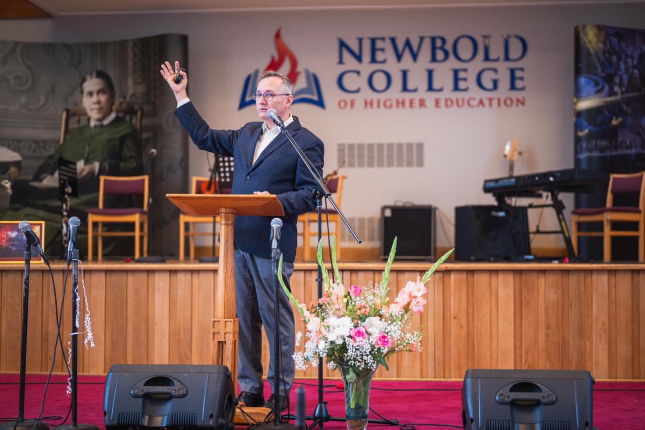 A speaker addressing the Ellen G. White Youth Symposium at Newbold