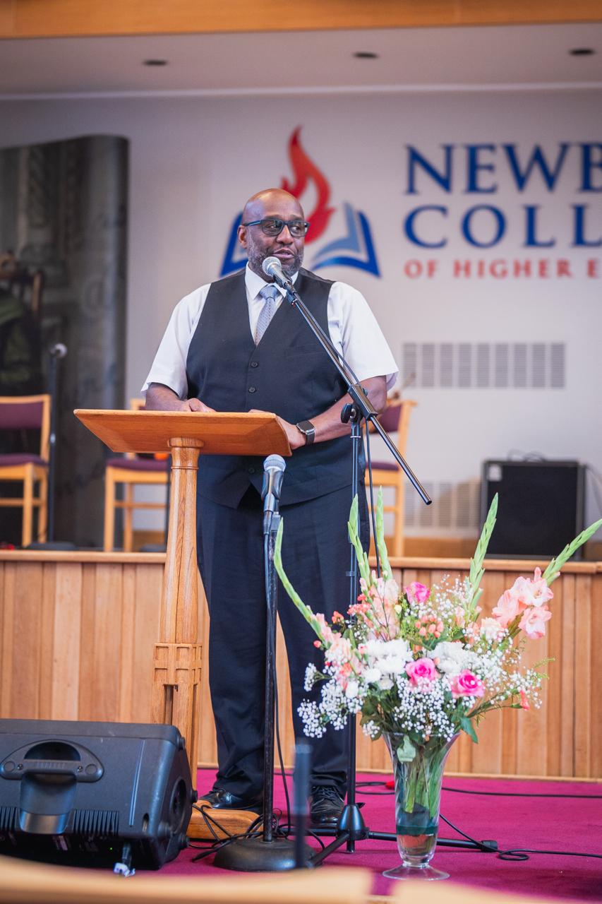 A speaker addressing the Ellen G. White Youth Symposium at Newbold