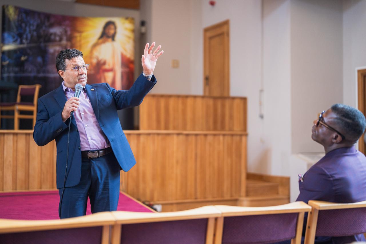 A speaker addressing the Ellen G. White Youth Symposium at Newbold