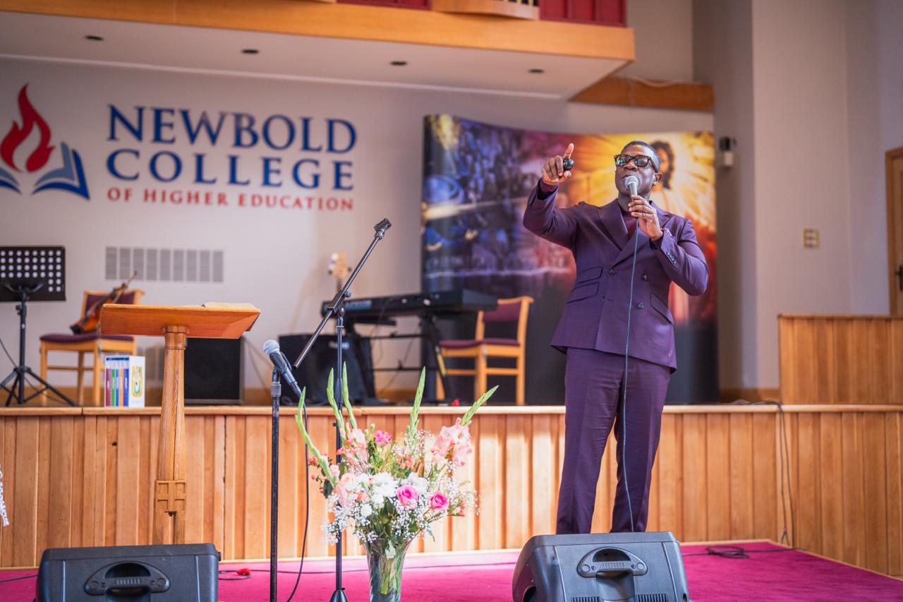 A speaker addressing the Ellen G. White Youth Symposium at Newbold