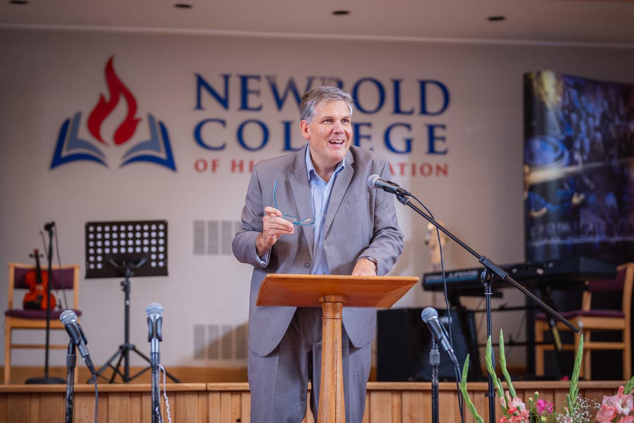 A speaker addressing the Ellen G. White Youth Symposium at Newbold