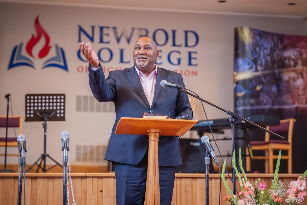 A speaker addressing the Ellen G. White Youth Symposium at Newbold