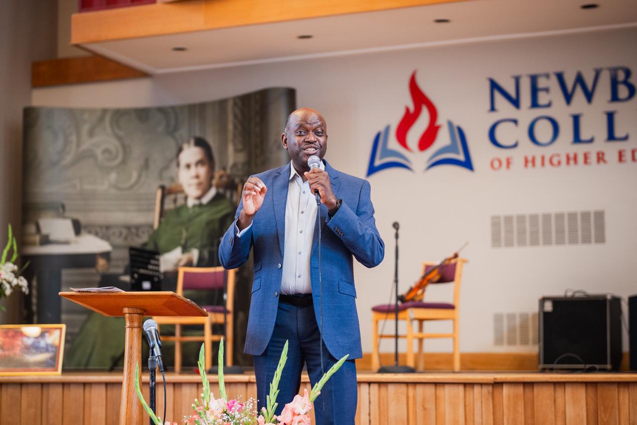 A speaker addressing the Ellen G. White Youth Symposium at Newbold